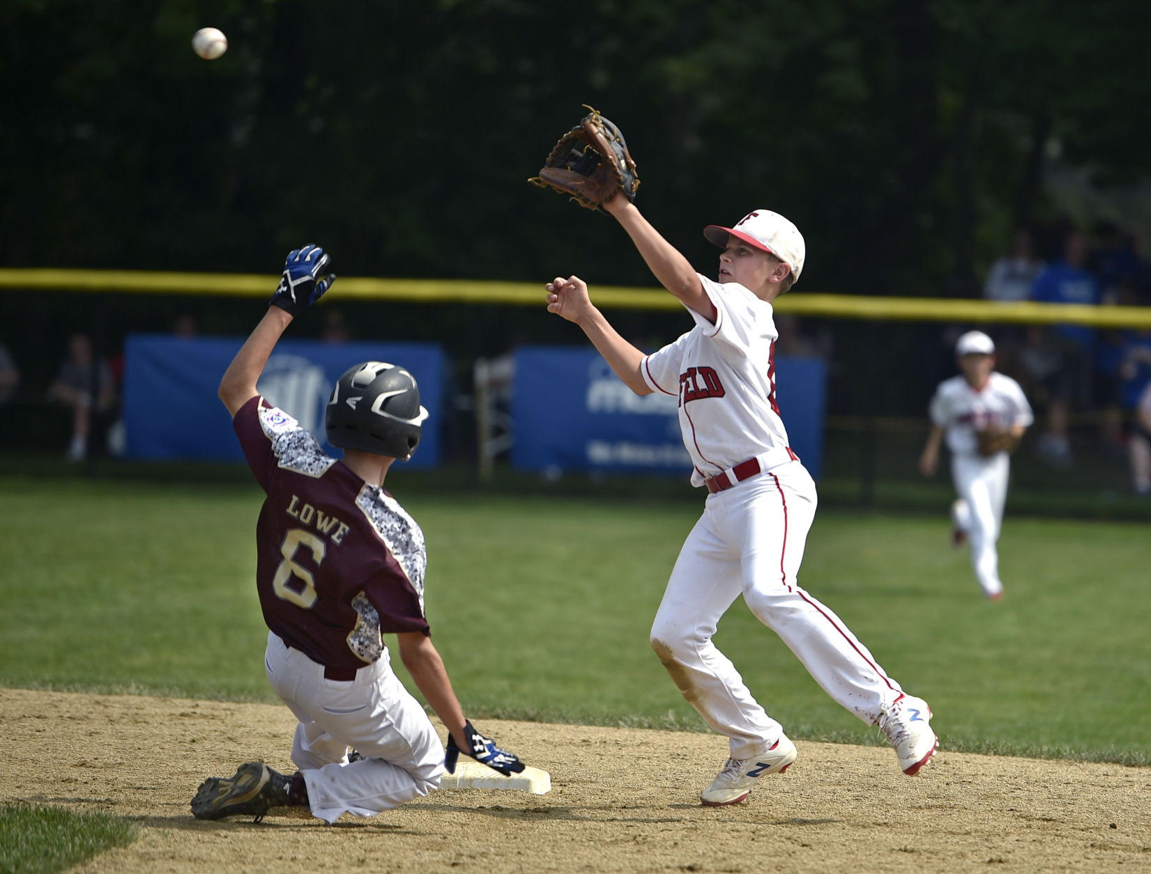 Fairfield American Little League shortstop Charlie Yates tries to tag out Maine baserunner during a regional game in Bristol last year. Even the powerhouse FALL has seen its participation decline in recent years.